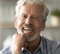 man smiling after getting dental implants