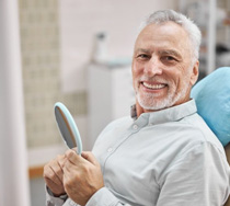 a patient smiling while visiting his dentist