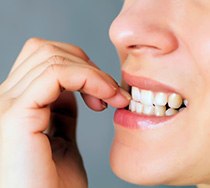 Closeup of woman biting her nails